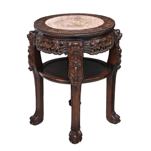 1492 - A Chinese carved hardwood and marble jardiniere stand, early 20th century, the circular top with cen... 