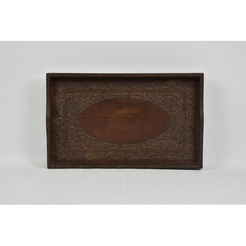 1508 - An Anglo-Indian carved hardwood tray, early 20th century, carved with foliage and flowers, with pier... 