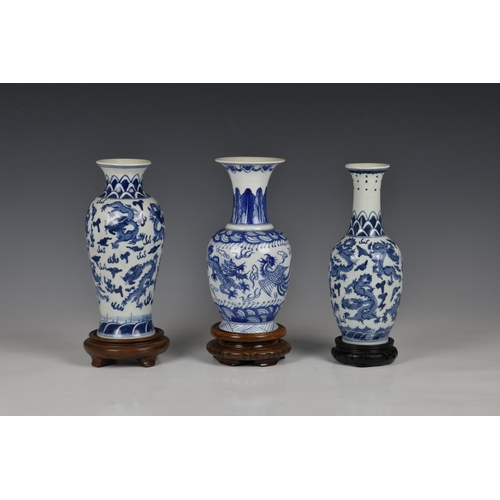 1514 - Three Chinese porcelain blue and white vases, 20th century, comprising a baluster vase with six char... 