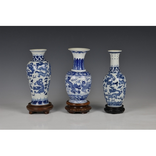 1514 - Three Chinese porcelain blue and white vases, 20th century, comprising a baluster vase with six char... 