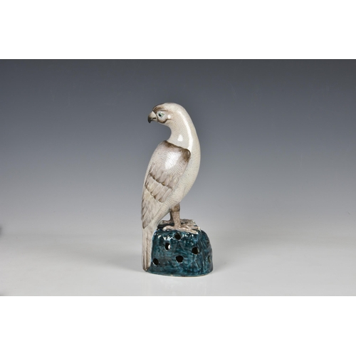 1521 - A Chinese export famille verte figure of a falcon or hawk, 20th century, modelled with its head turn... 