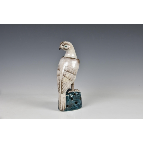 1521 - A Chinese export famille verte figure of a falcon or hawk, 20th century, modelled with its head turn... 