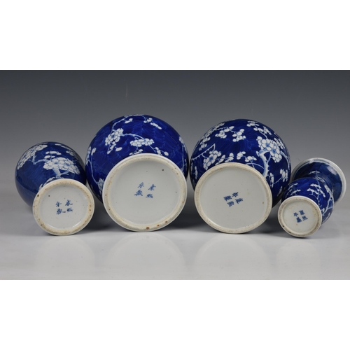 1527 - Four Chinese blue and white prunus blossom decorated vases, 20th century, comprising an inverted bal... 