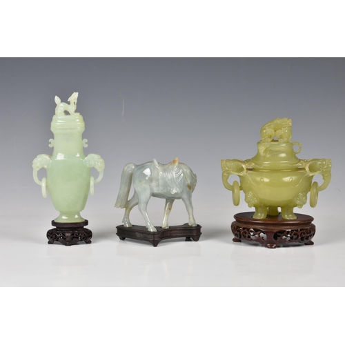 1542 - Three Chinese jade style hardstone carvings, 20th century, comprising a covered tripod censer, in pa... 