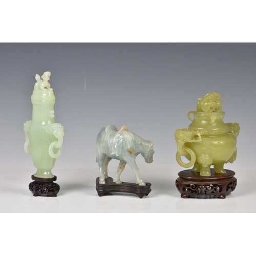 1542 - Three Chinese jade style hardstone carvings, 20th century, comprising a covered tripod censer, in pa... 