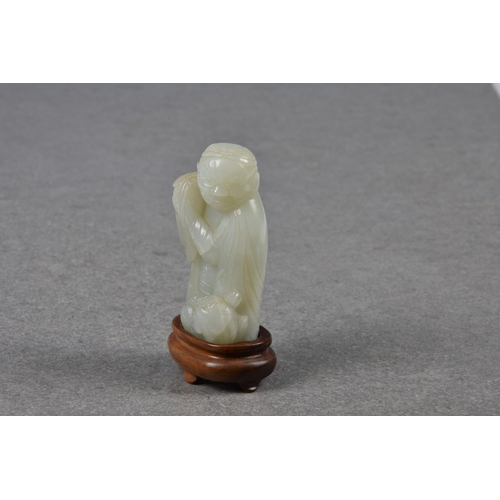 1555 - A Chinese pale celadon carving of an elderly man and fo dog, probably Qing dynasty, the robed man we... 