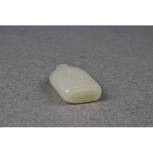 1557 - A Chinese celadon jade snuff bottle, of rectangular form with rounded shoulders and shallow, slightl... 