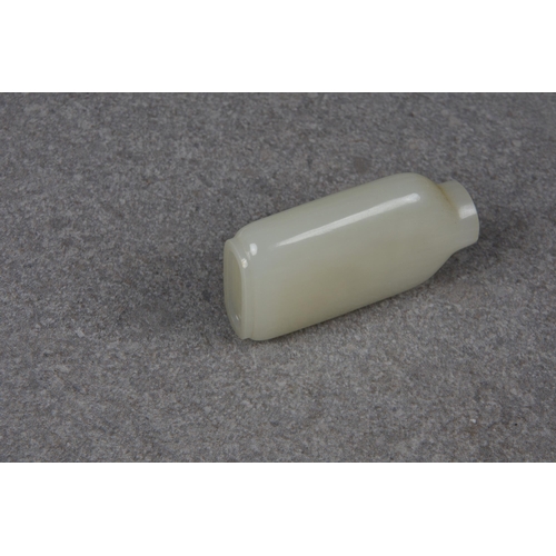 1557 - A Chinese celadon jade snuff bottle, of rectangular form with rounded shoulders and shallow, slightl... 