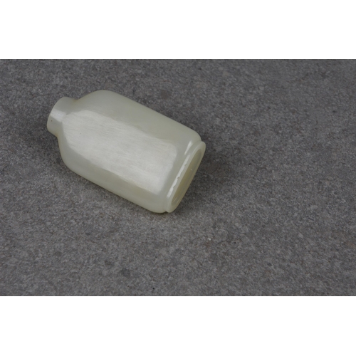 1557 - A Chinese celadon jade snuff bottle, of rectangular form with rounded shoulders and shallow, slightl... 