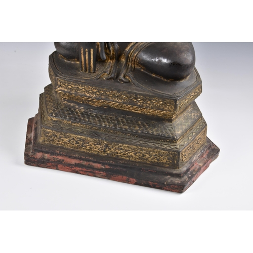 1586 - A 19th century Burmese Mandalay dry lacquer seated figure of Buddha, seated in dhyanasana on a tiere... 