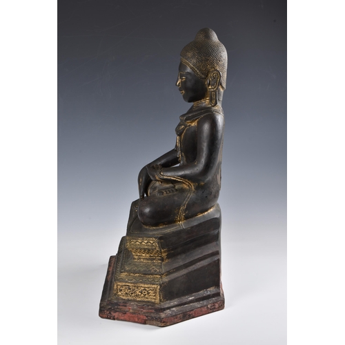 1586 - A 19th century Burmese Mandalay dry lacquer seated figure of Buddha, seated in dhyanasana on a tiere... 