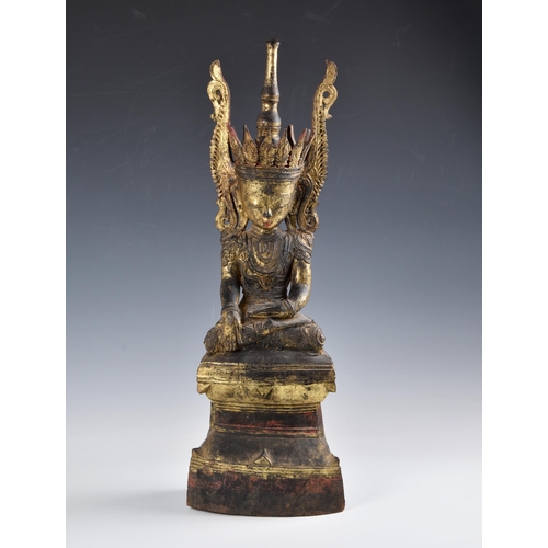 1587 - A Burmese, Shan States style carved gilt decorated Buddha, probably 19th century, the carved wooden ... 