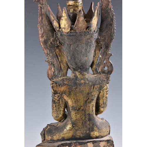 1587 - A Burmese, Shan States style carved gilt decorated Buddha, probably 19th century, the carved wooden ... 