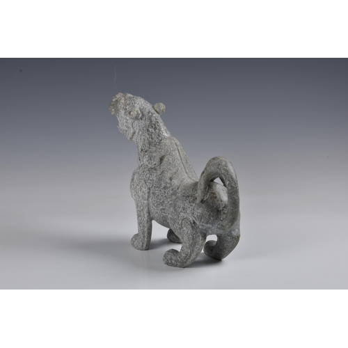 1589 - A large Chinese greenish-grey jade figure of a mythical lion, 20th century, the jade with pale mottl... 