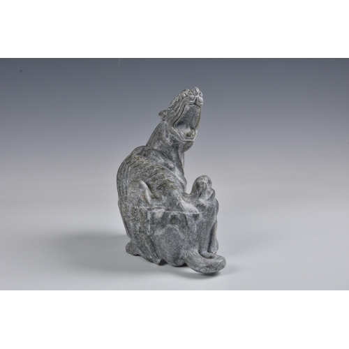 1590 - A large Chinese greenish-grey jade figure of a mythical beast, 20th century, the muscular creature w... 