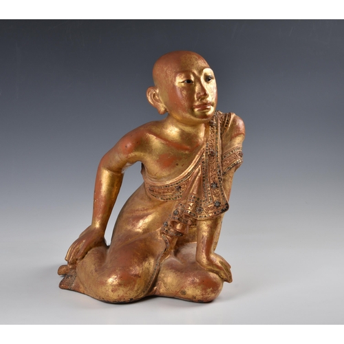 1592 - A Burmese Mandalay carved, lacquered and jewelled gilt wood figure of a seated monk, probably late 1... 