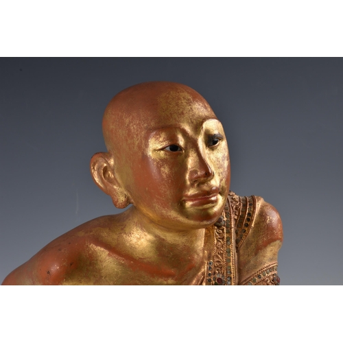 1592 - A Burmese Mandalay carved, lacquered and jewelled gilt wood figure of a seated monk, probably late 1... 