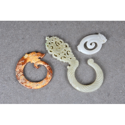 1607 - A Chinese white jade pendant of a coiled dragon and rat, 3in. (7.6cm.) long; together with a pale ce... 