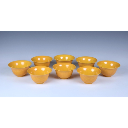 1617 - A set of eight Chinese yellow glazed anhua bowls, the exteriors lightly carved with two long bodied ... 