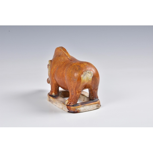 1629 - A Chinese chestnut glazed model of a boar, probably Tang Dynasty (618-907), the glaze with a file cr... 