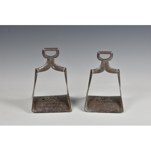 1644 - A pair of 19th century Indo-Persian wrought iron stirrups with white and yellow metal damascened dec... 