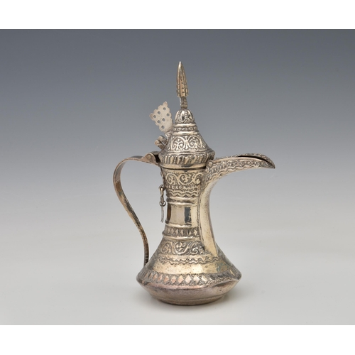 1645 - A Middle-Eastern white metal Dallah coffee pot, all over decorated with repeating stylised foliate a... 