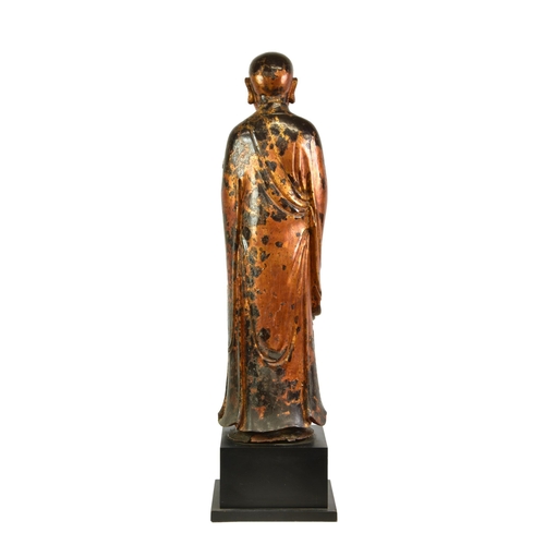 1659 - A lacquered and gilt carved wooden figure of a standing monk or Lohan, probably Burmese, Mandalay pe... 