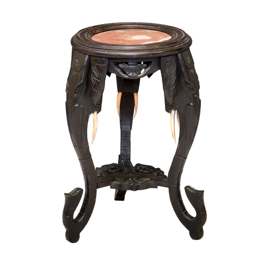 1663 - An Oriental ebonised and marble elephant jardiniere stand, 1920s, the dished top with inset marble, ... 