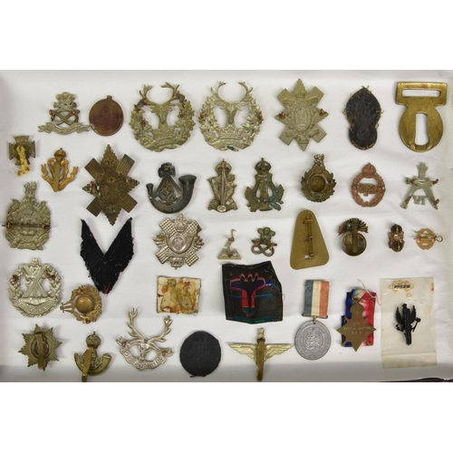 1780 - A large collection of approximately one hundred & thirty (130) various Military cap badges / patches... 