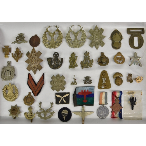 1780 - A large collection of approximately one hundred & thirty (130) various Military cap badges / patches... 