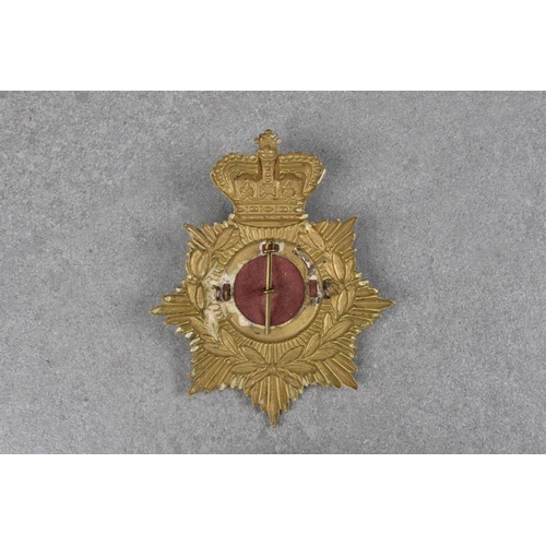 1819 - A Royal Guernsey Light Infantry brass helmet plate, bearing Crown, laurel and centred by insignia on... 