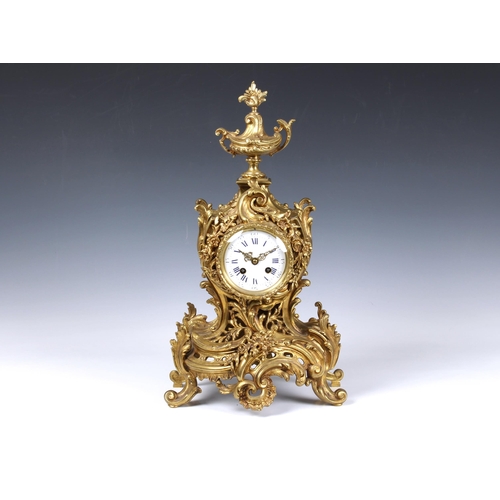 1940 - A large French gilt brass rococo revival mantel clock, early 20th century, the signed twin train mov... 