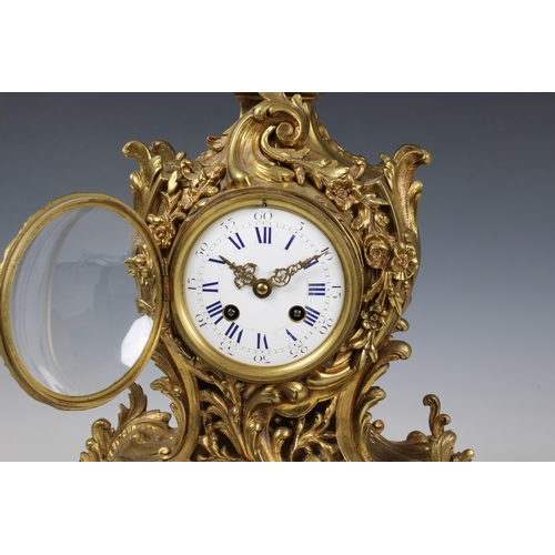 1940 - A large French gilt brass rococo revival mantel clock, early 20th century, the signed twin train mov... 