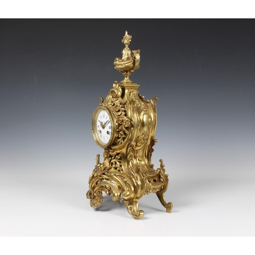 1940 - A large French gilt brass rococo revival mantel clock, early 20th century, the signed twin train mov... 