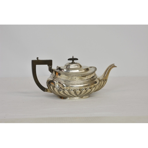 199 - An Edwardian silver teapot, William Aitken, Birmingham 1905, of oval bellied form with ebony handle ... 