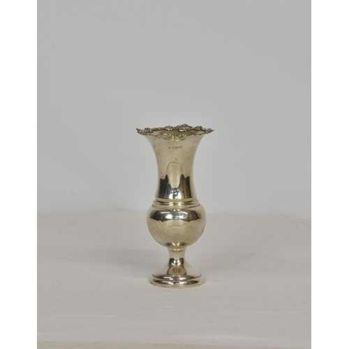 204 - A silver baluster vase, hallmarks indistinct, London, with cast floral rim, 7in. (7.75cm), weighted.... 