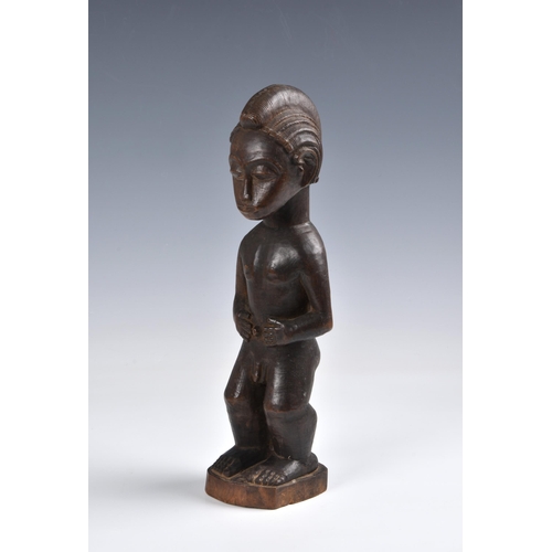 2088 - A Baule standing male figure, Ivory Coast, West Africa, probably mid-20th century, the carved wooden... 