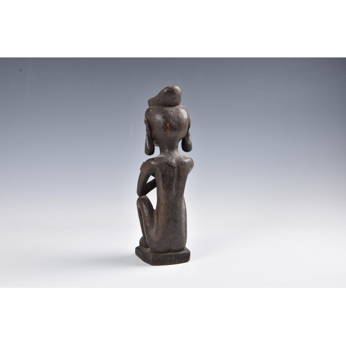 2094 - Tribal art - A carved wooden ancestor figure, Indonesia, probably Leti Islands, seated with arms cro... 