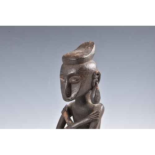 2094 - Tribal art - A carved wooden ancestor figure, Indonesia, probably Leti Islands, seated with arms cro... 