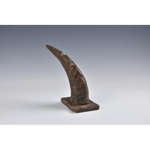 2096 - Tribal art - A carved horn figure of a dancer in an elephant mask, with brass coin button to the bel... 