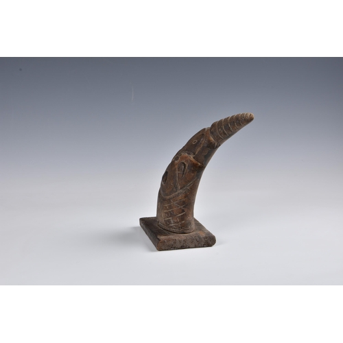 2096 - Tribal art - A carved horn figure of a dancer in an elephant mask, with brass coin button to the bel... 