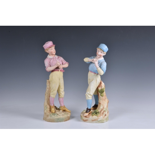 22 - A rare pair of German Heubach biscuit porcelain figures of baseball players, c.1890, the batter wear... 