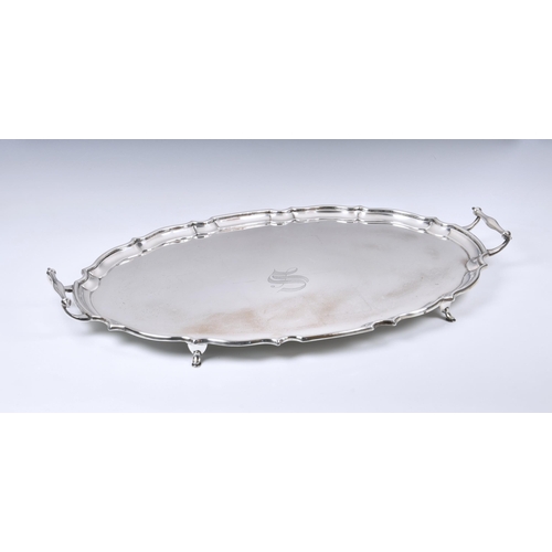 229 - An Edwardian twin handle silver tray, Barker Brothers, Chester 1908, oval form with pie-crust rim, e... 