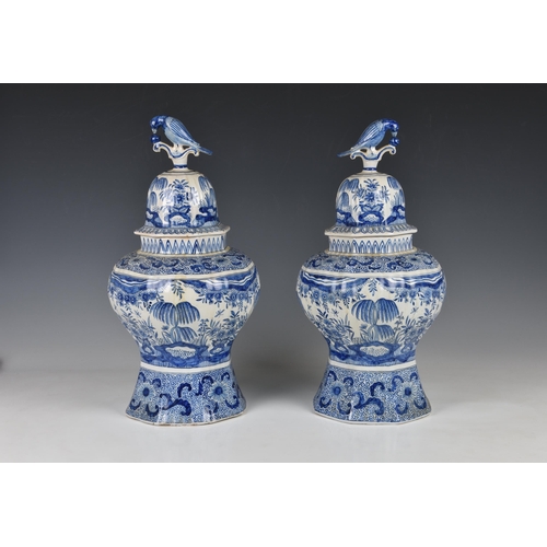 24 - A pair of Dutch Delft vases and covers, probably 20th century, baluster form with flared, octagonal ... 