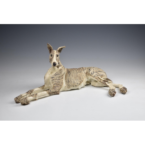 34 - Elaine Peto (British, b.1963), a studio pottery stoneware model of a recumbent dog, impressed potter... 