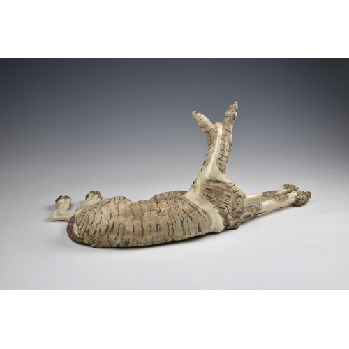 34 - Elaine Peto (British, b.1963), a studio pottery stoneware model of a recumbent dog, impressed potter... 