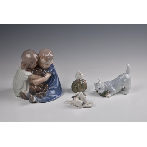 39 - A Royal Copenhagen porcelain figure group, depicting a pair of seated children cuddling a puppy, No.... 