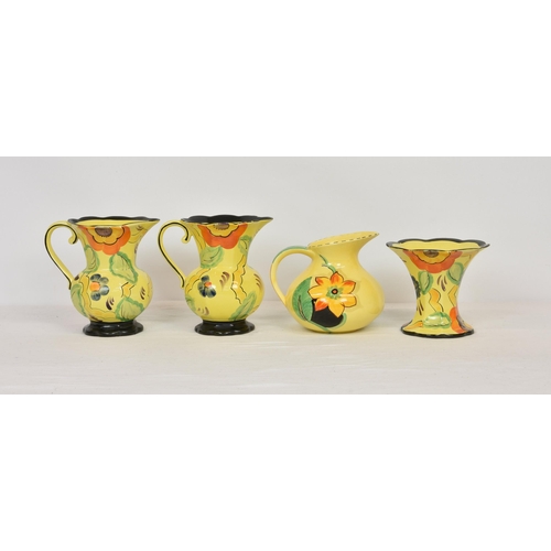 49 - A pair of Wade Heath 1930s sunflower pattern hand painted jugs, 7 ¾ in. (19.7cm.) high, with matchi... 