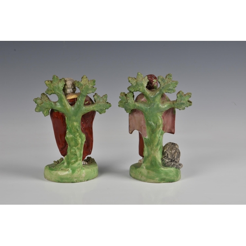 54 - Two Staffordshire 19th century pottery figures of saints, to include 'ST.MARK', standing in front of... 