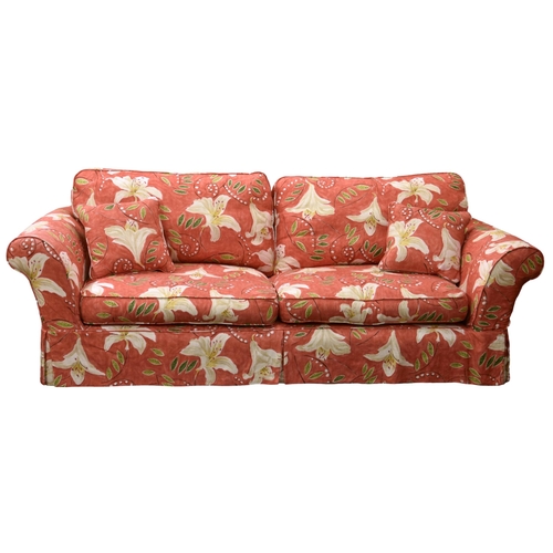 A pair of three seater sofas, in lily pattern fabric, 85 x 38in. (216 x
